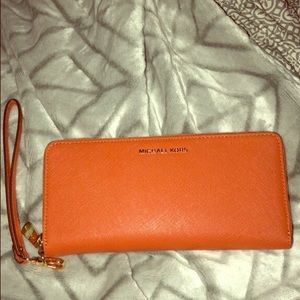 Orange Michael Kors leather wristlet.